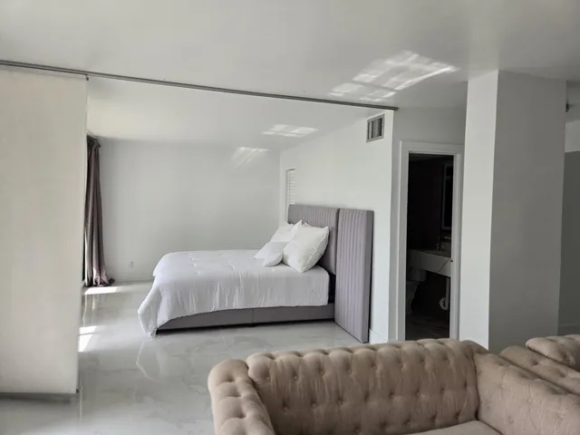 a bedroom with a bed and a couch