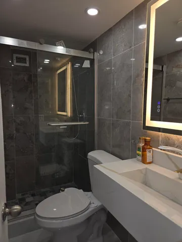 a bathroom with a toilet a sink and shower