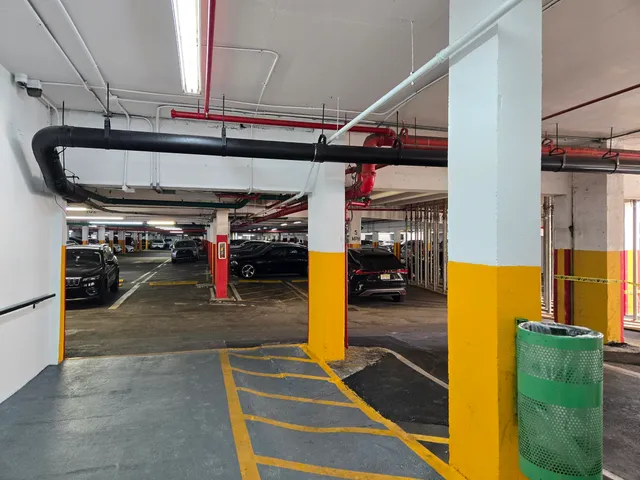 a view of a workspace with furniture and a bookshelf