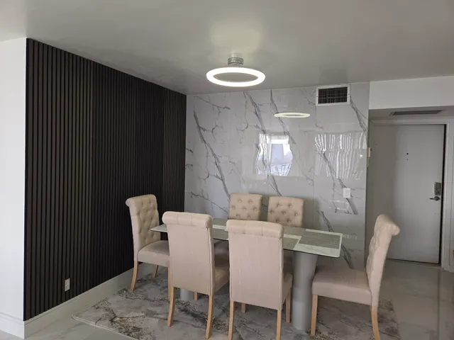 a view of a dining room with furniture and a chandelier