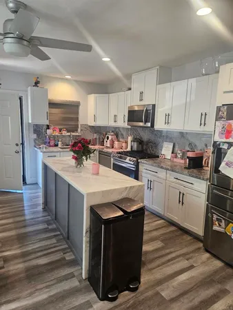 a kitchen with a sink stove top oven and refrigerator