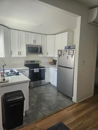 a kitchen with a sink stove and refrigerator