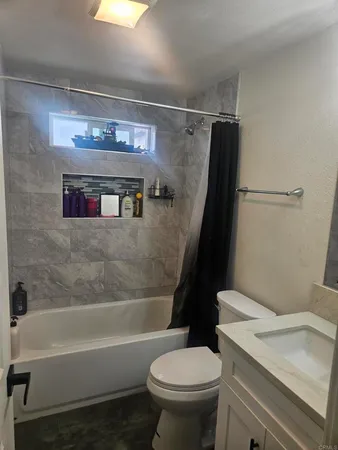 a bathroom with a sink a toilet and a bathtub