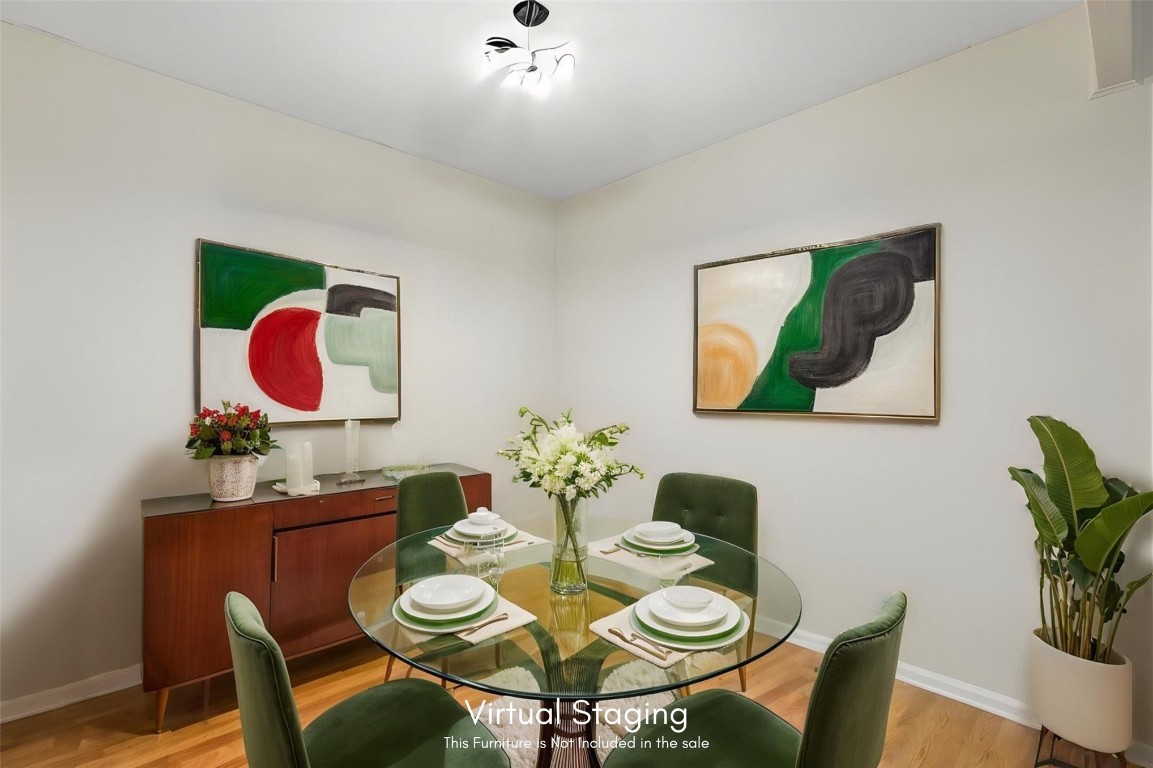 2583 Forest Ridge Drive, Unit N3 Fernandina Beach, FL 32034 - Photo 11 of 34 a view of a dining room with furniture a potted plant and wooden floor