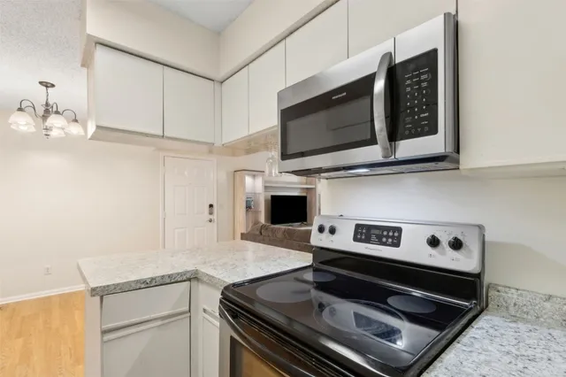 a kitchen with a stove and a microwave