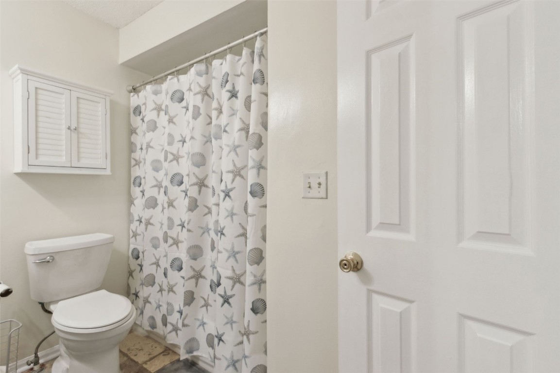 2583 Forest Ridge Drive, Unit N3 Fernandina Beach, FL 32034 - Photo 25 of 34 a white toilet sitting next to a shower curtain