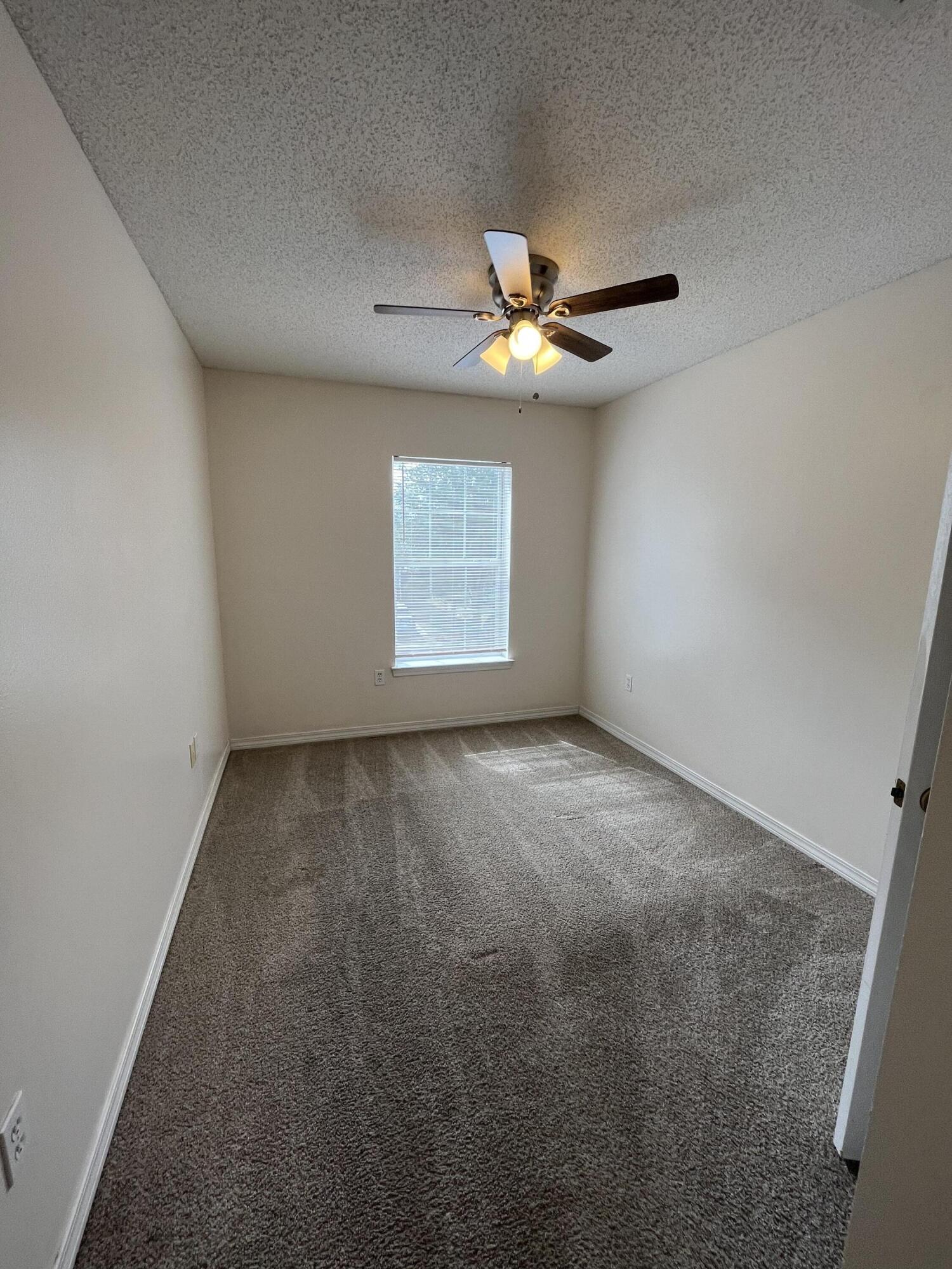204 Johnson Court Crestview, FL 32536 - Photo 11 of 17 an empty room with windows and ceiling fan
