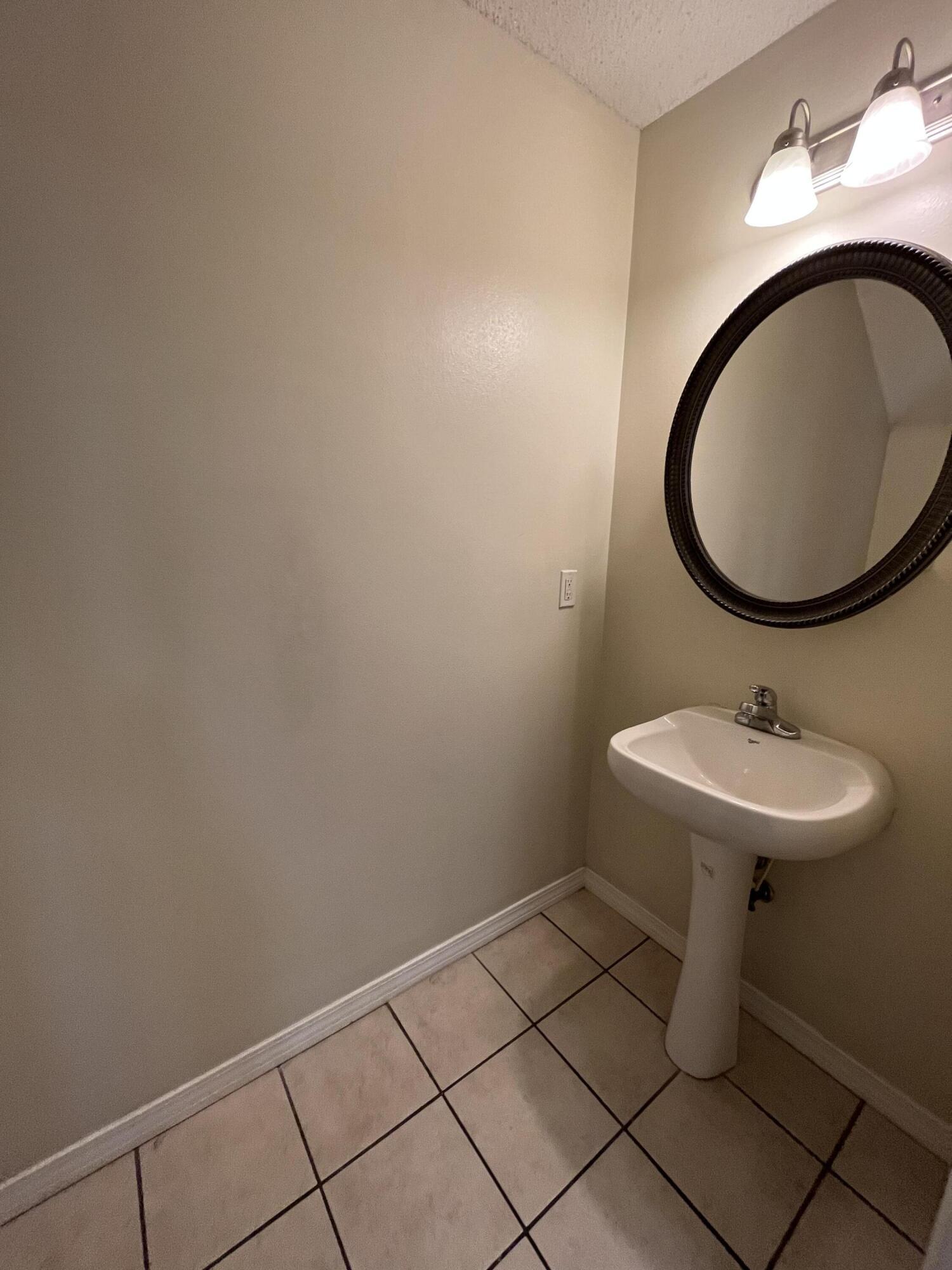 204 Johnson Court Crestview, FL 32536 - Photo 4 of 17 a bathroom with a sink and a mirror