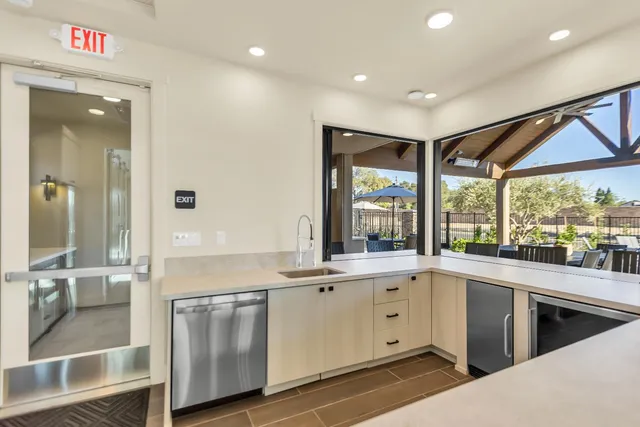 a large white kitchen with a large window
