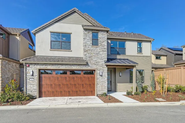 a front view of a house with a garage