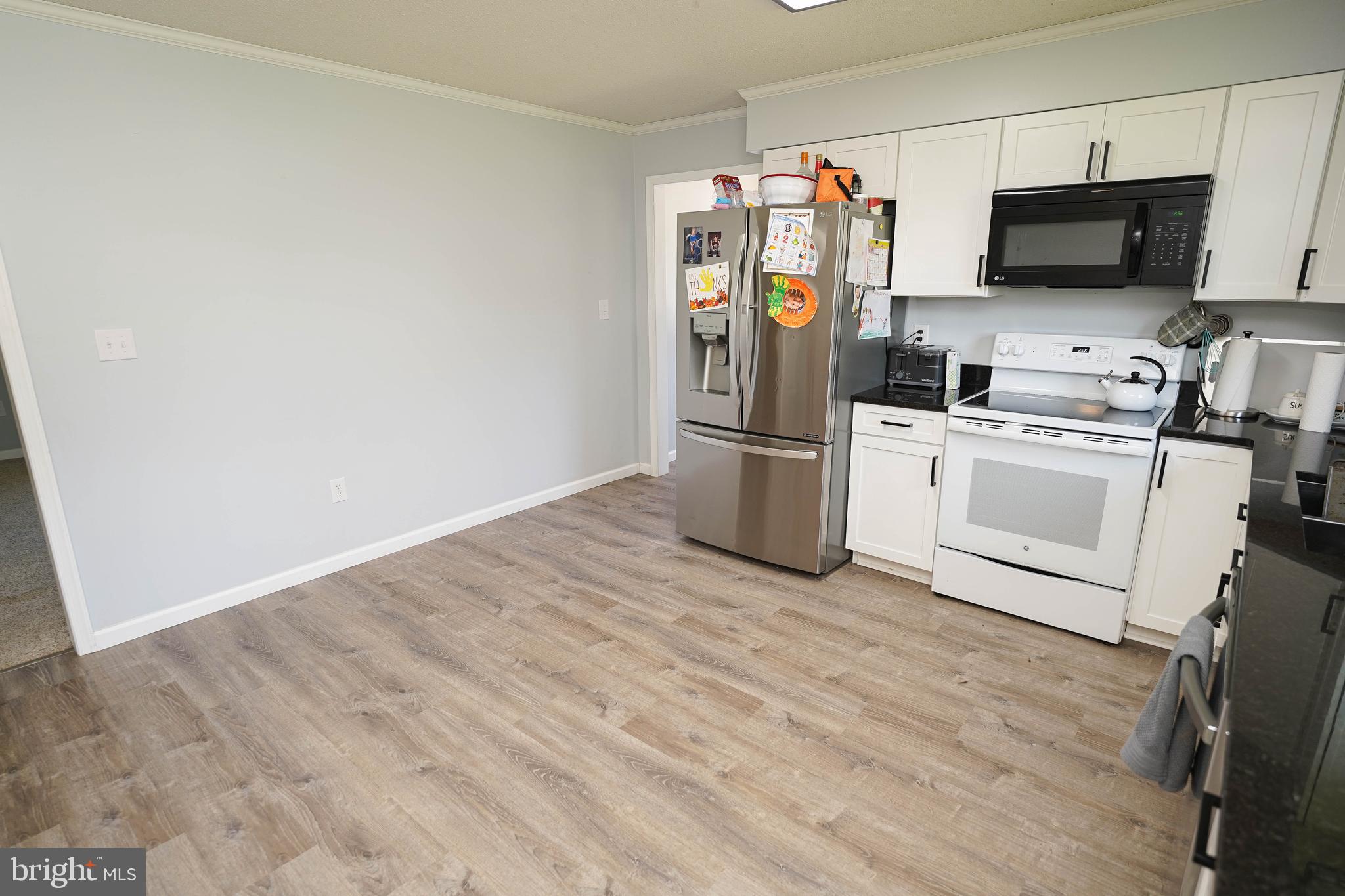 10564 Waller Road Laurel, DE 19956 - Photo 11 of 33 a kitchen with stainless steel appliances a stove microwave and refrigerator