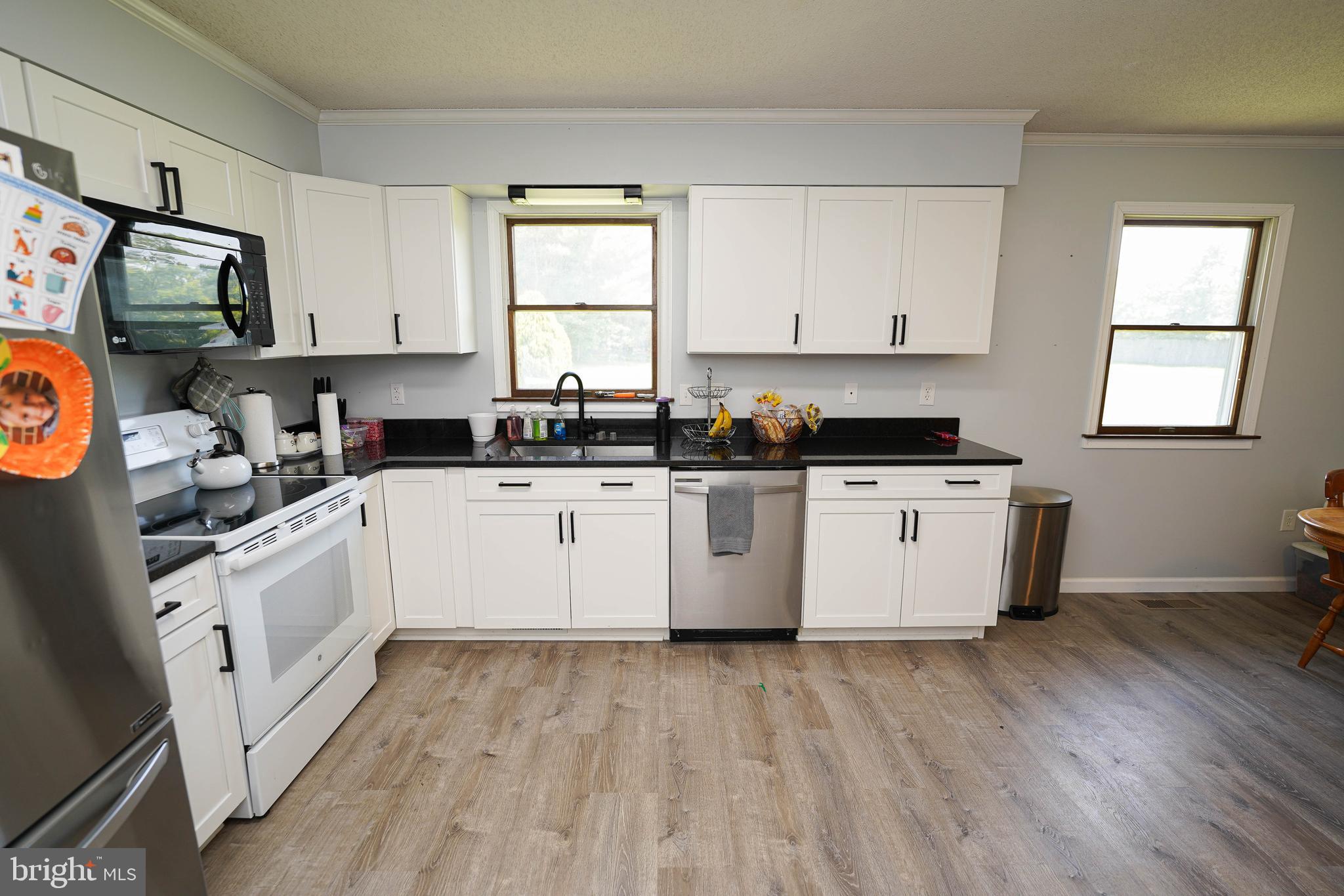 10564 Waller Road Laurel, DE 19956 - Photo 14 of 33 a kitchen with stainless steel appliances a white stove top oven sink and cabinets