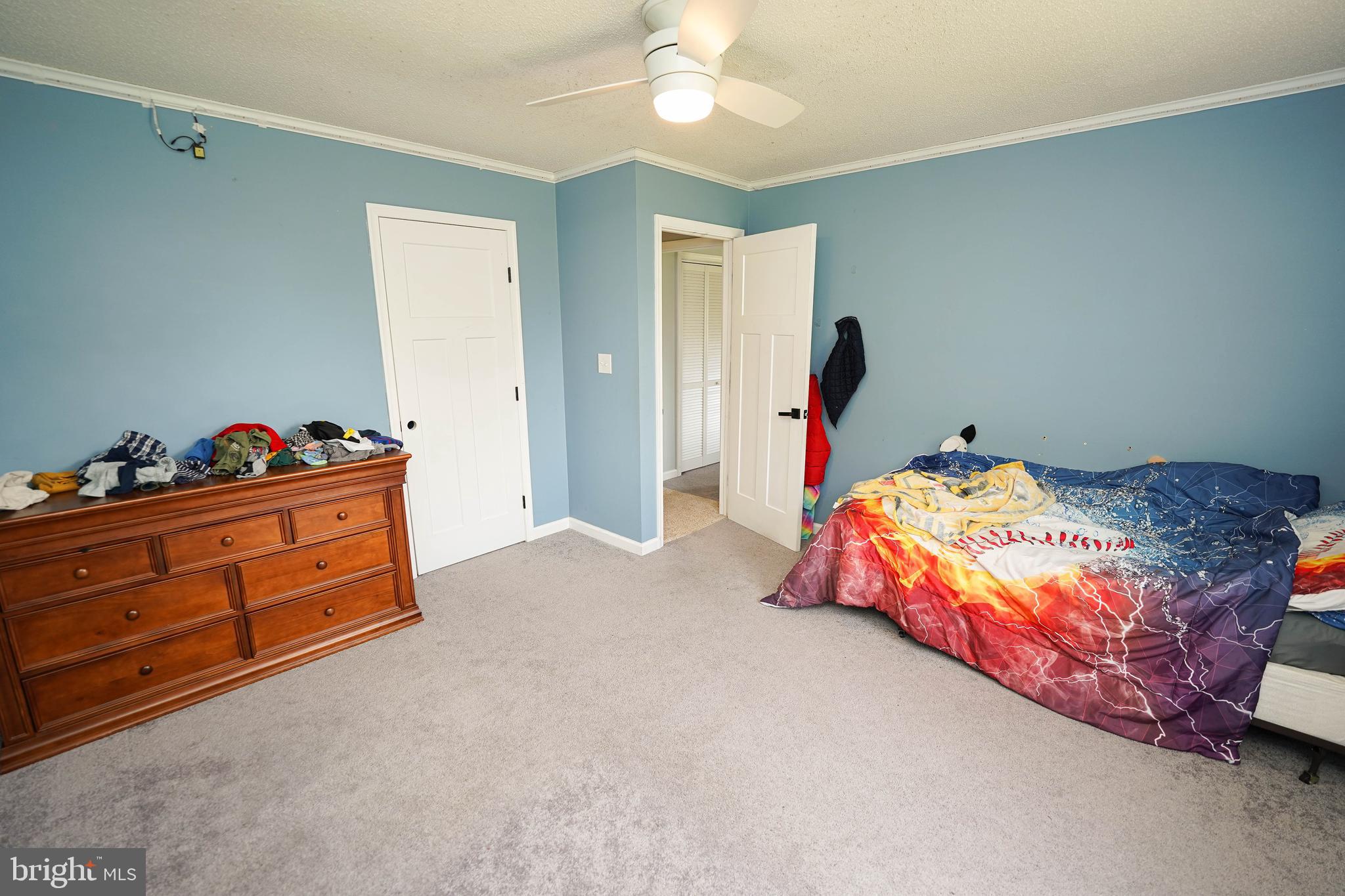 10564 Waller Road Laurel, DE 19956 - Photo 22 of 33 a bedroom with a bed and a chandelier