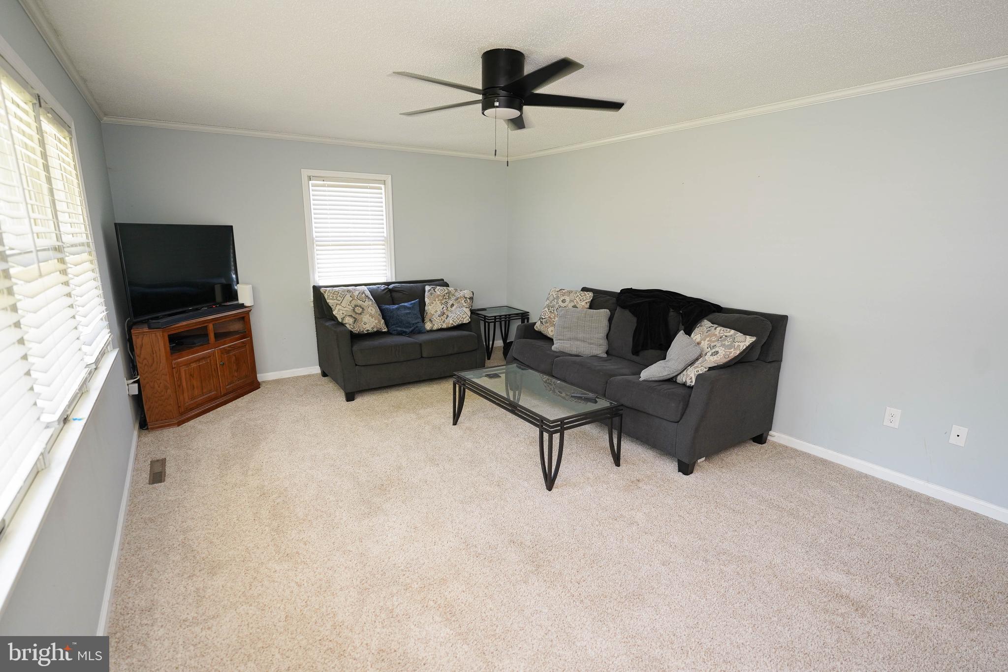 10564 Waller Road Laurel, DE 19956 - Photo 7 of 33 a living room with furniture and a flat screen tv