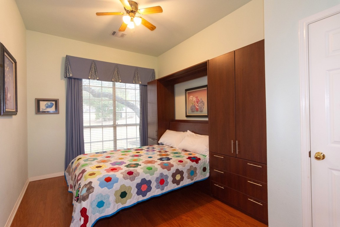 11401 Ohmfield Court Austin, TX 78739 - Photo 16 of 40 a bedroom with a bed and a window