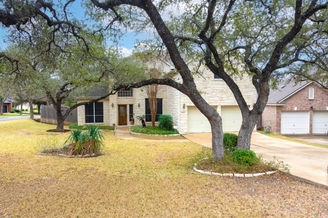 11401 Ohmfield Court Austin, TX 78739 - Photo 2 of 40 a front view of a house with a yard and large tree