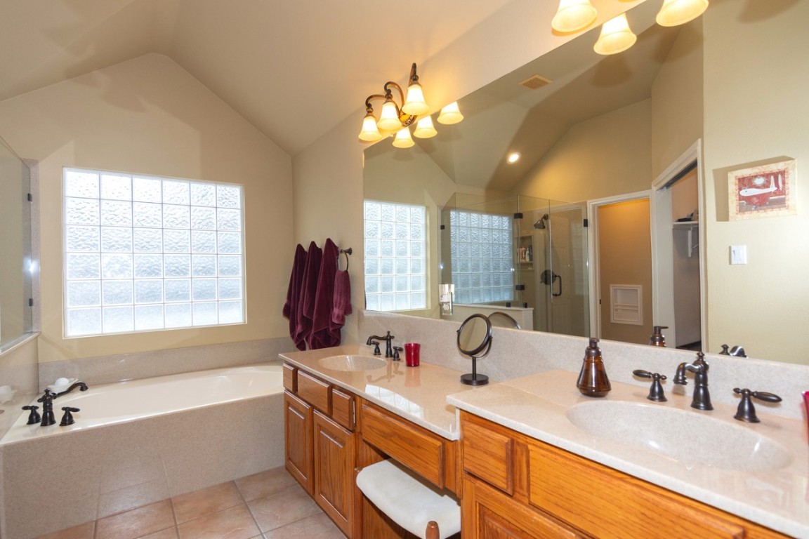 11401 Ohmfield Court Austin, TX 78739 - Photo 22 of 40 a bathroom with a tub sink and mirror