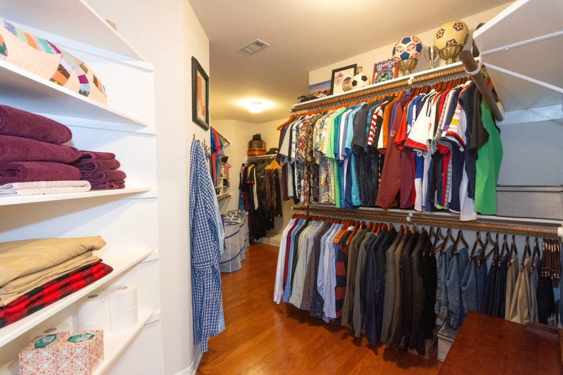 11401 Ohmfield Court Austin, TX 78739 - Photo 24 of 40 a view of walk in closet with clothes and shoes