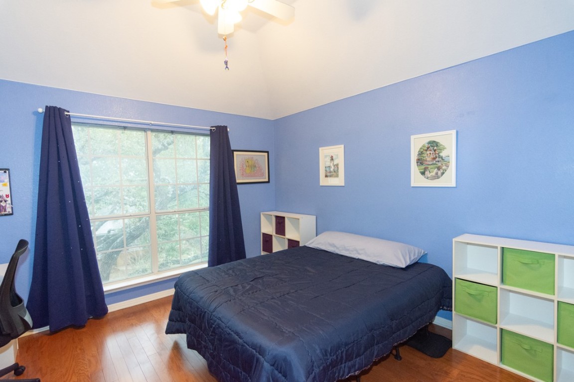 11401 Ohmfield Court Austin, TX 78739 - Photo 25 of 40 a bed sitting in a bedroom next to a window