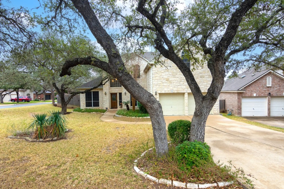 11401 Ohmfield Court Austin, TX 78739 - Photo 3 of 40 a front view of a house with a yard