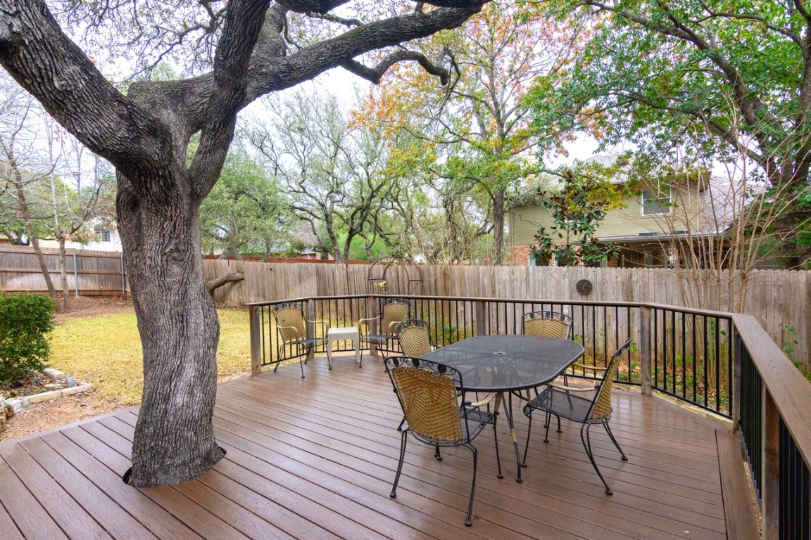 11401 Ohmfield Court Austin, TX 78739 - Photo 31 of 40 a view of a deck with table and chairs and wooden floor