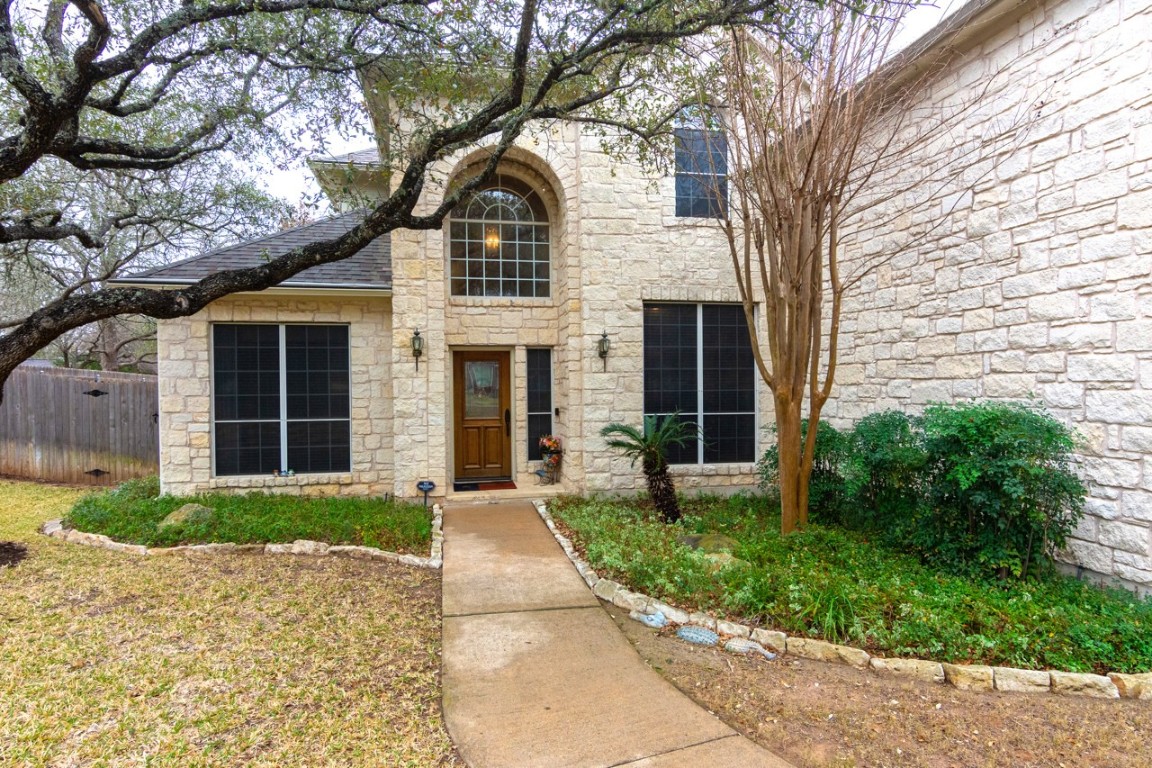 11401 Ohmfield Court Austin, TX 78739 - Photo 5 of 40 a front view of a house with garden and plants