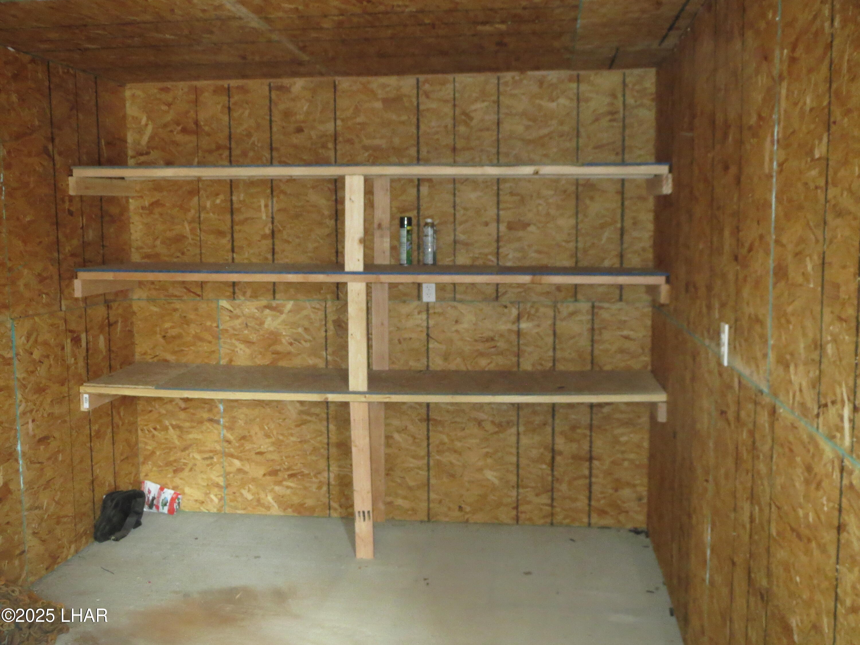 11964 Nolan Road Yucca, AZ 86438 - Photo 21 of 29 Interior of 10 ft X 30 Ft. Storage building with interior lighting electrical and concrete foundation