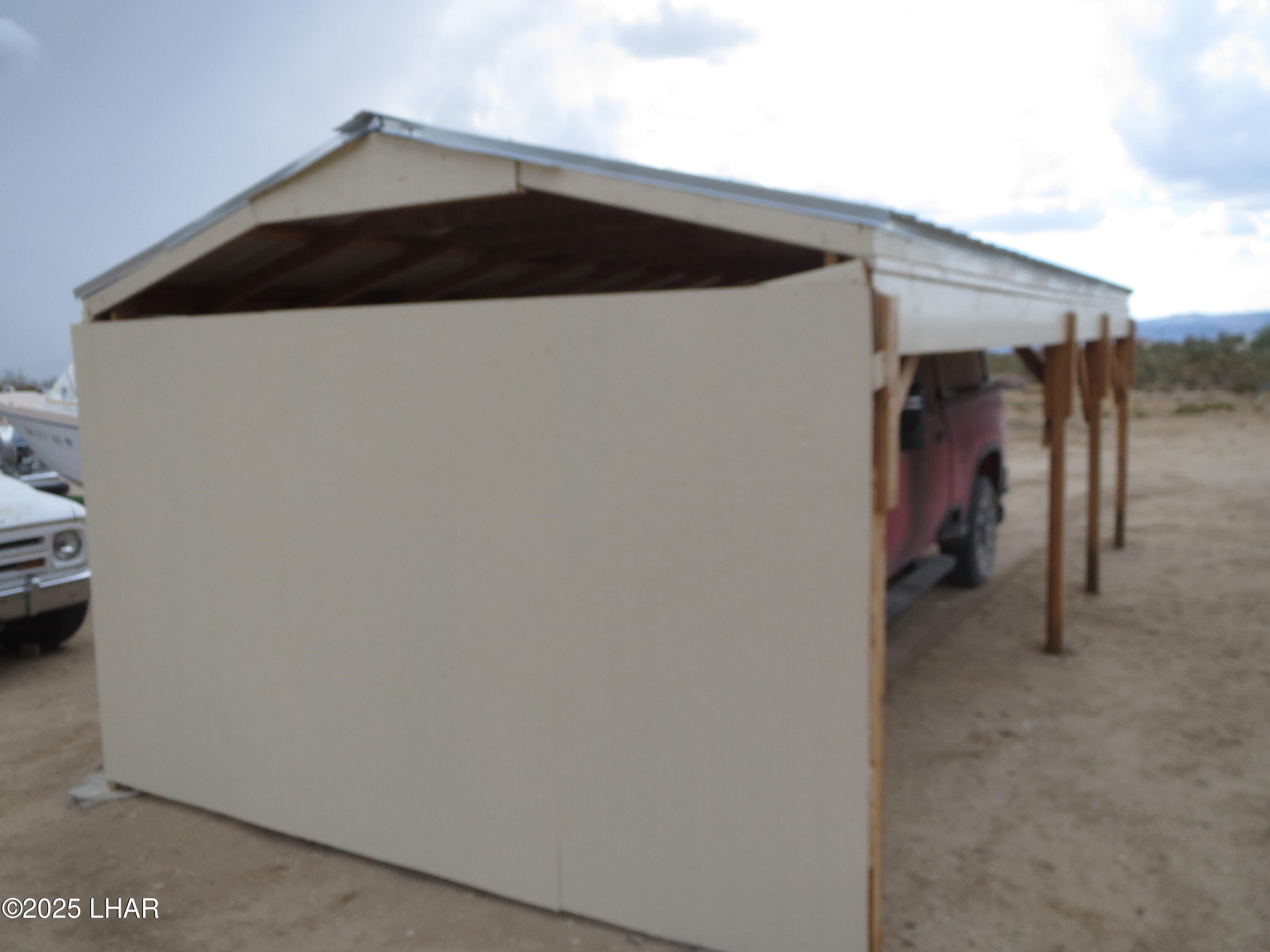 11964 Nolan Road Yucca, AZ 86438 - Photo 28 of 29 Rear of one of three covered carports.