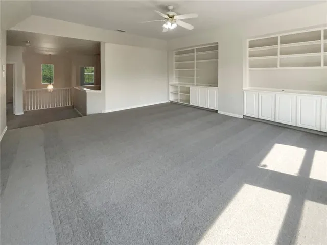 a view of empty room with a window and fireplace