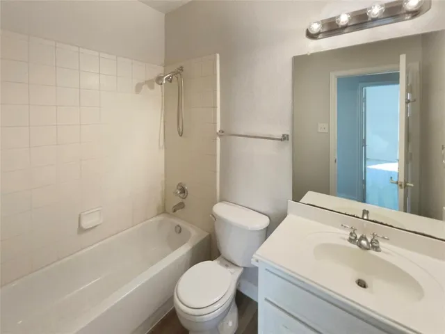 a bathroom with a tub shower and sink