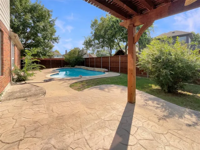 a view of a backyard with sitting area