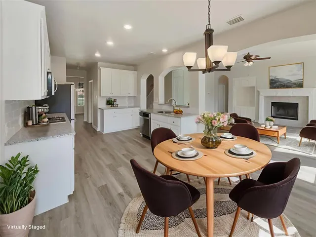 a view of a dining room with furniture and wooden floor