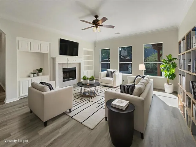 a living room with furniture fireplace and a flat screen tv