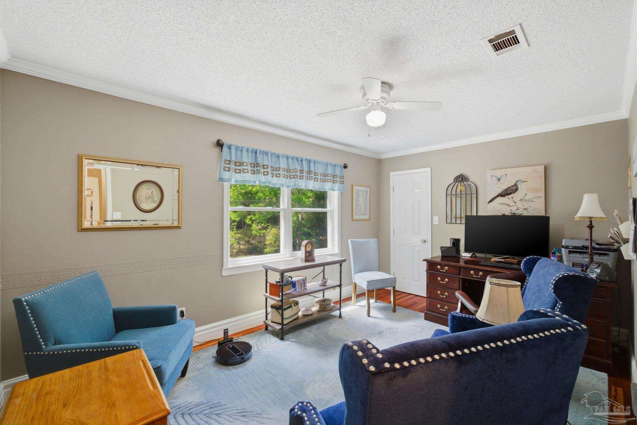 6930 Summit Way Milton, FL 32570 - Photo 33 of 71 a living room with furniture and a flat screen tv