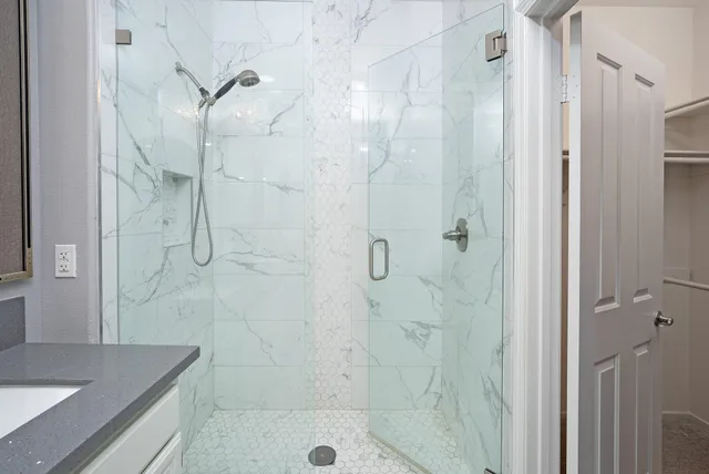 a bathroom with a shower and a sink
