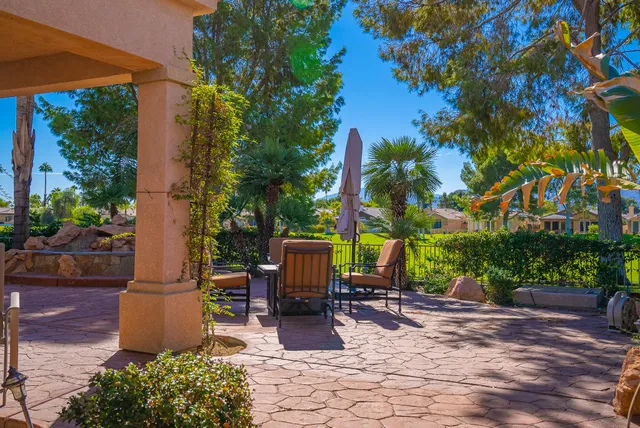 a view of a dinning table and chairs in patio of the house