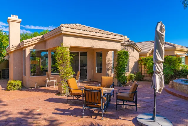 a view of a patio with table and chairs and potted plants
