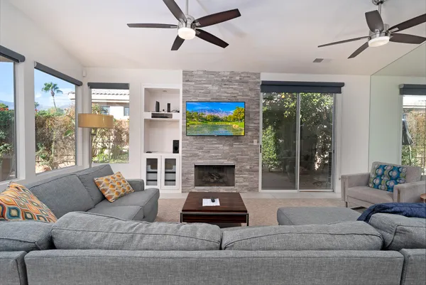 a living room with furniture and a fireplace
