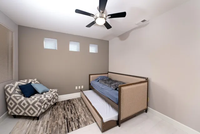 a bedroom with bed and a couch