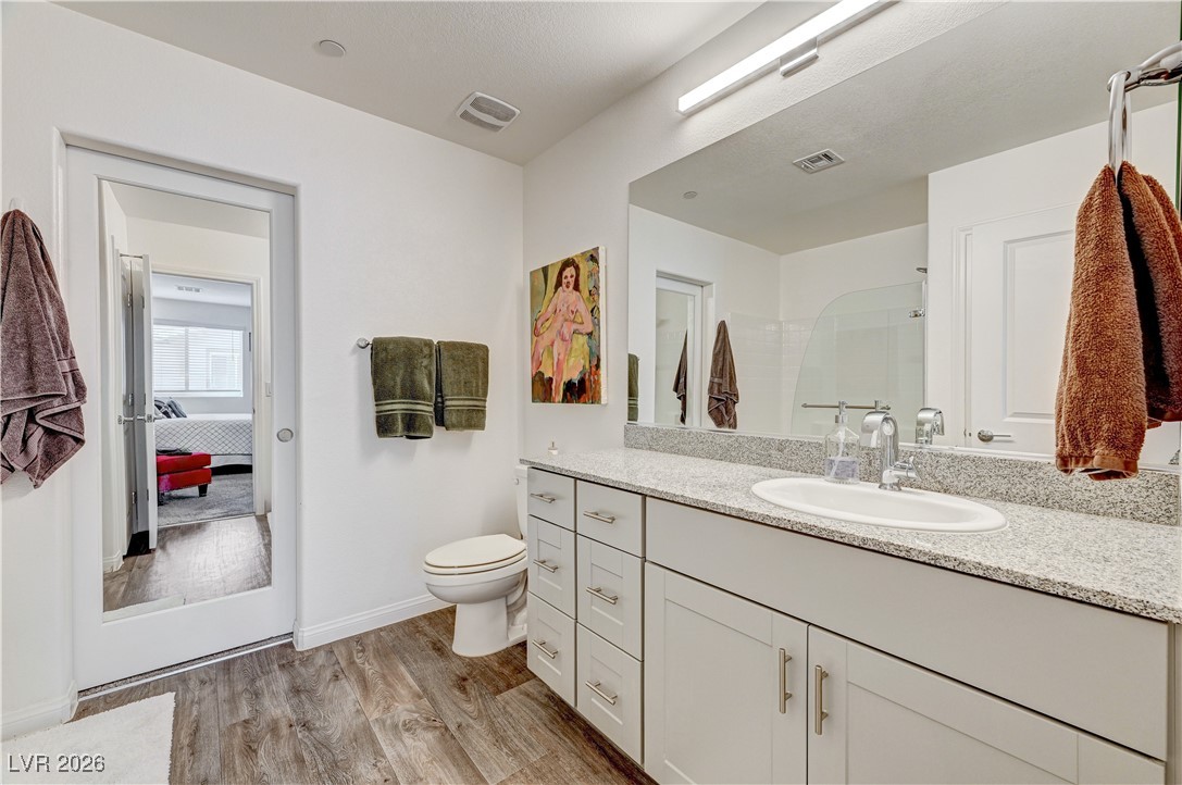 12183 Mojave Gold Road, Unit 2 Las Vegas, NV 89183 - Photo 16 of 42 Primary bathroom with mirrored pocket door entryway to walk-in closet