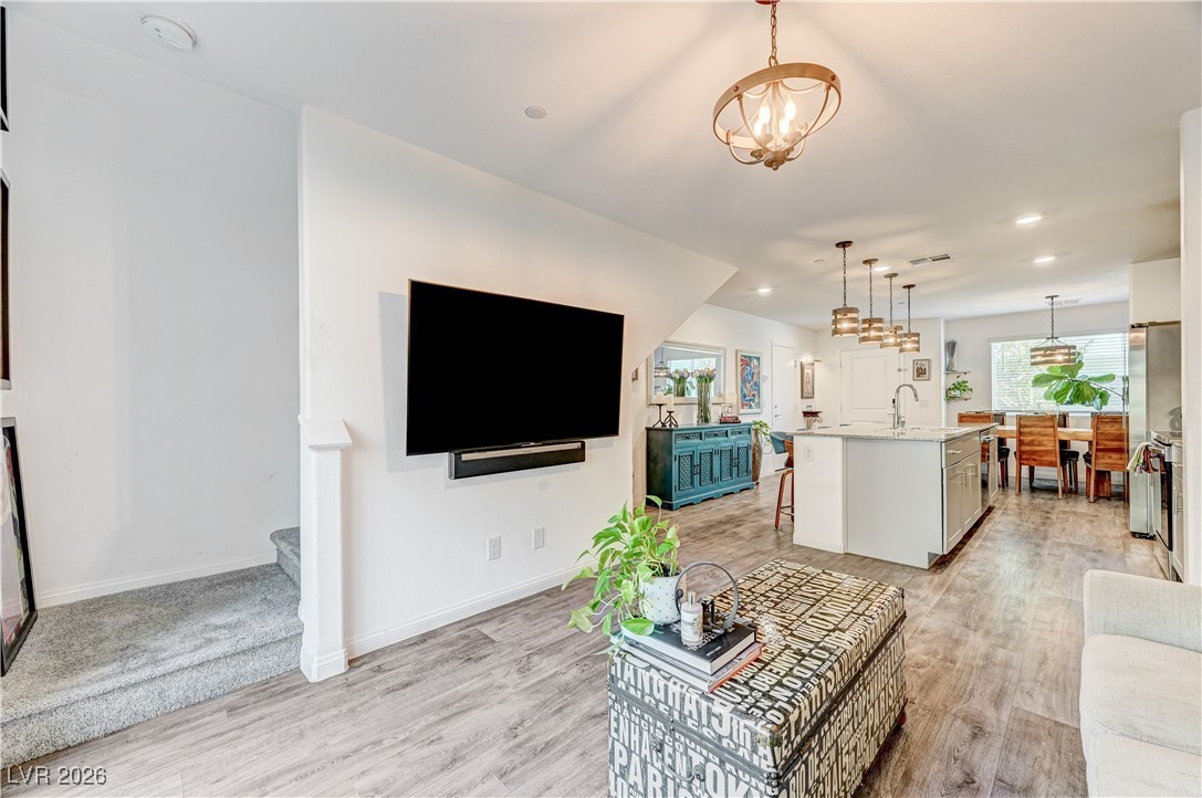 12183 Mojave Gold Road, Unit 2 Las Vegas, NV 89183 - Photo 10 of 42 Living room with hallway stairs to second floor