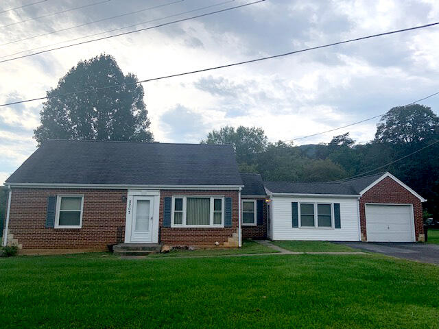 5207 Lewis Road Roanoke, VA 24014 - Photo 1 of 6 a front view of a house with a yard and garage