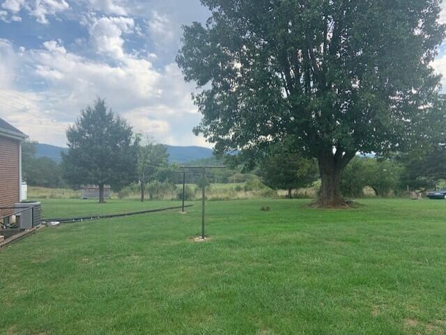 5207 Lewis Road Roanoke, VA 24014 - Photo 3 of 6 a view of outdoor space with green field and trees