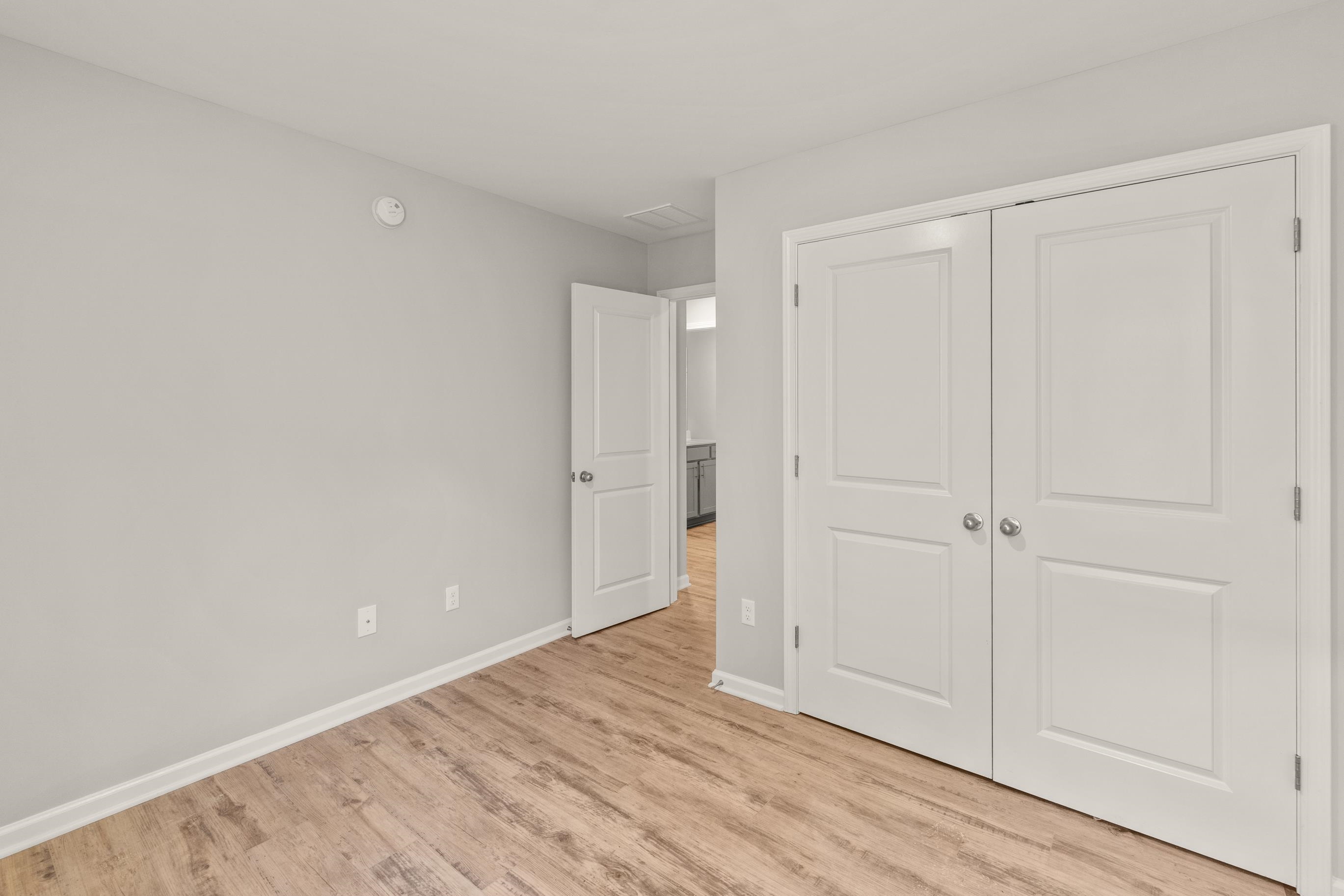 5273 Zodiac Road Memphis, TN 38118 - Photo 7 of 9 Unfurnished bedroom featuring light wood-style floors and a closet