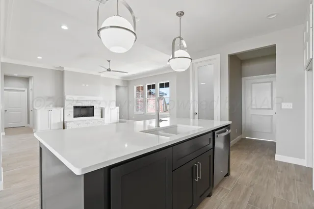 a kitchen with a sink a counter space and cabinets
