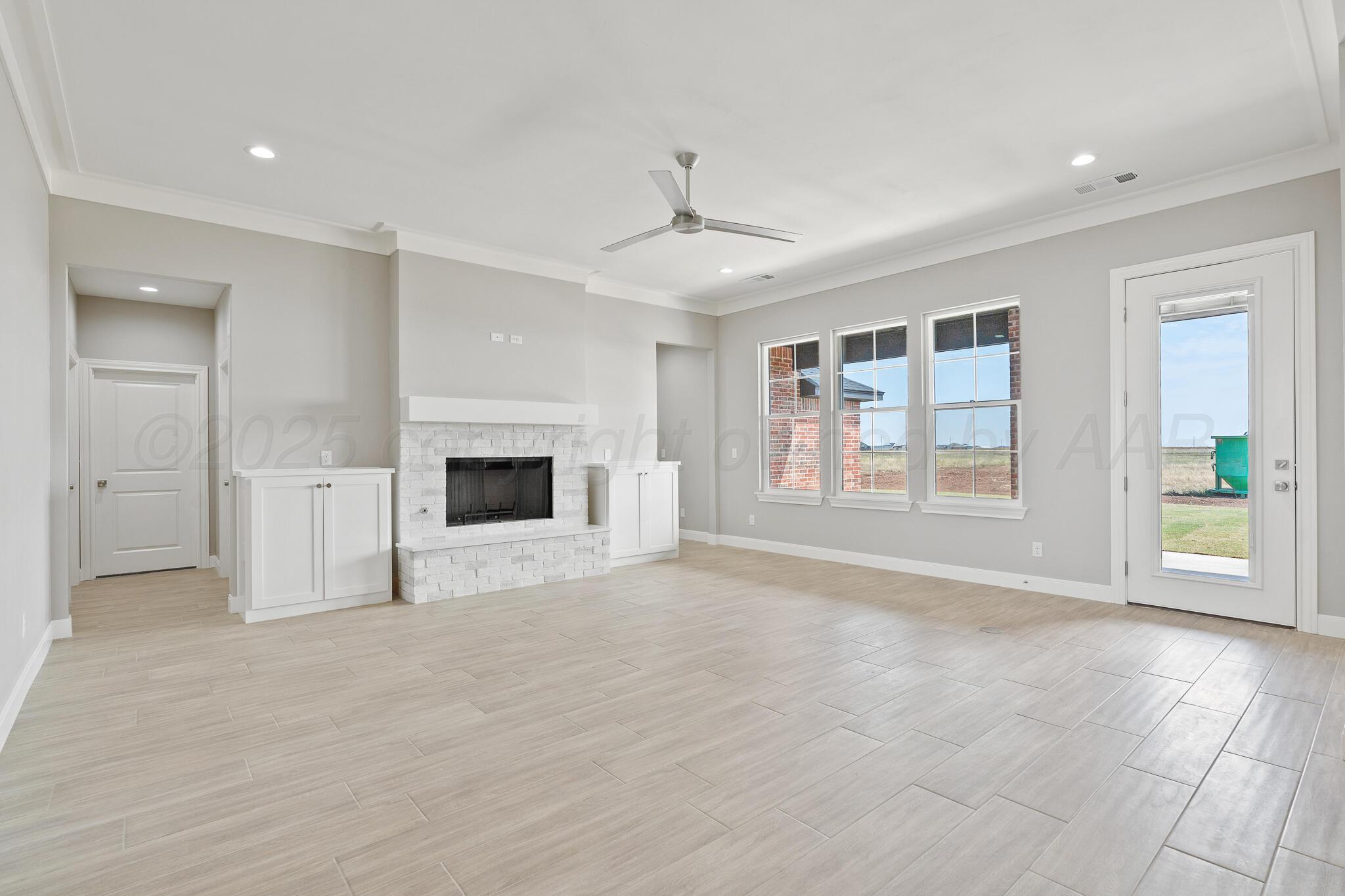 3551 Whitetail Springs Road Amarillo, TX 79119 - Photo 13 of 33 an empty room with windows and fireplace