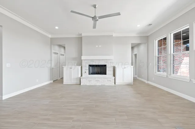 a view of empty room with a fireplace