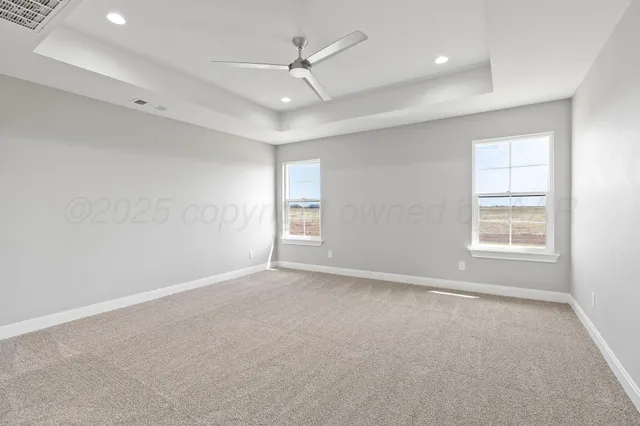 an empty room with a ceiling fan and a window