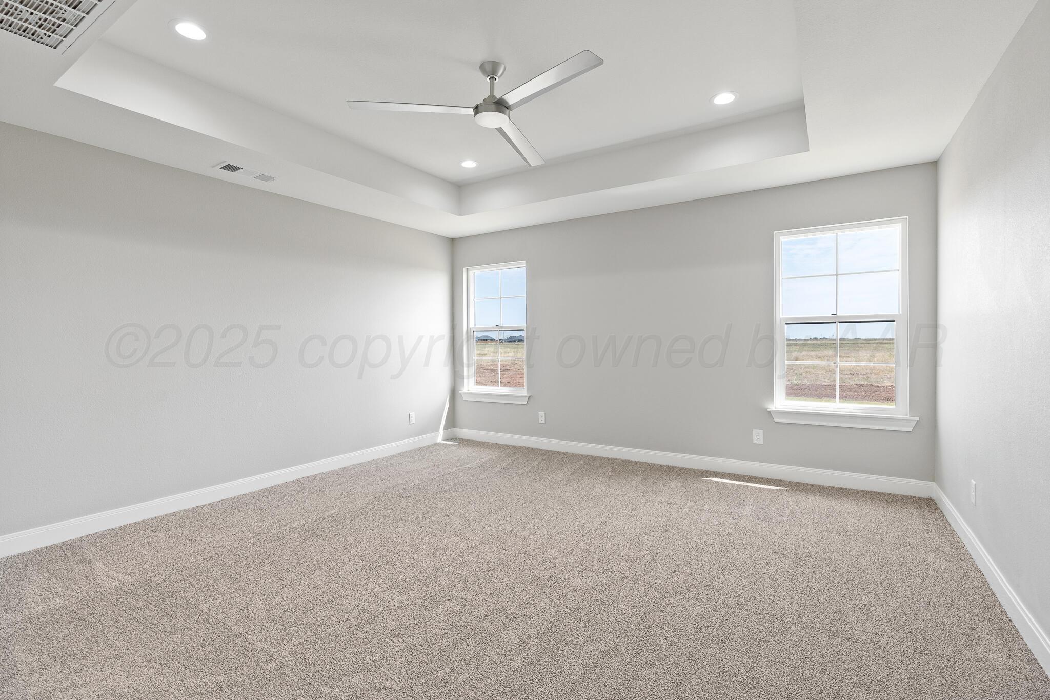 3551 Whitetail Springs Road Amarillo, TX 79119 - Photo 21 of 33 an empty room with windows and fan
