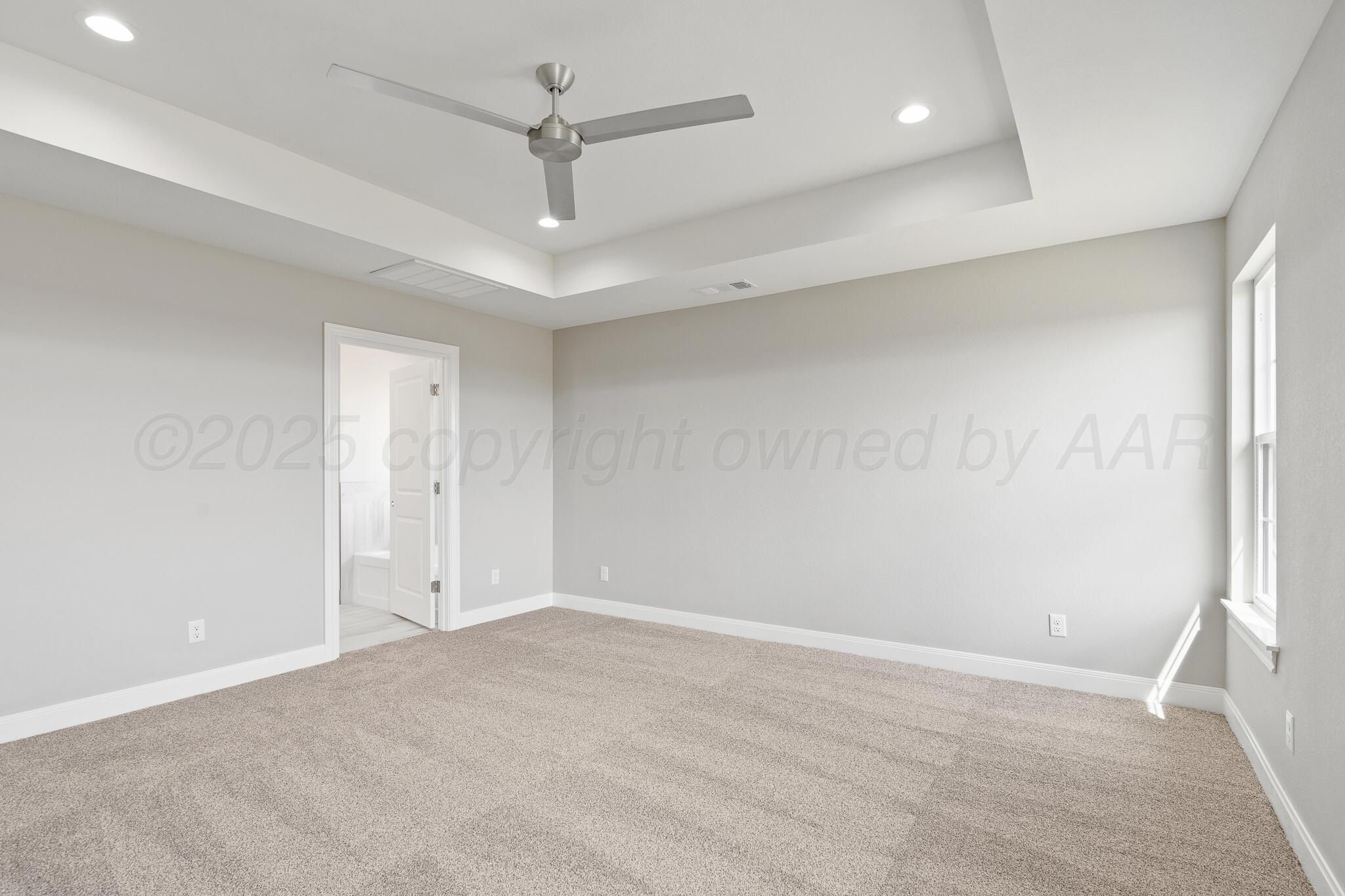 3551 Whitetail Springs Road Amarillo, TX 79119 - Photo 22 of 33 an empty room with a ceiling fan and a window